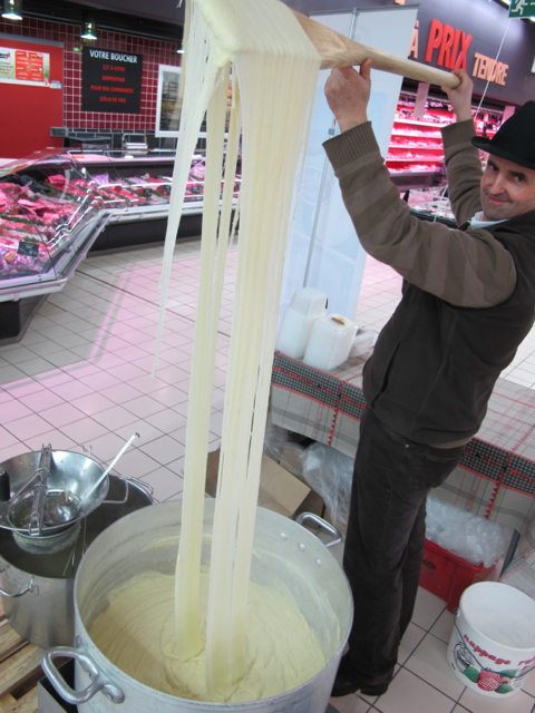 Saturday morning at the supermarche... preparing delicious 'Aligot'  - yes, a delightfully light, refreshing dish, composed of cheese, cream, potatoes, cheese, garlic, butter and then some more cheese